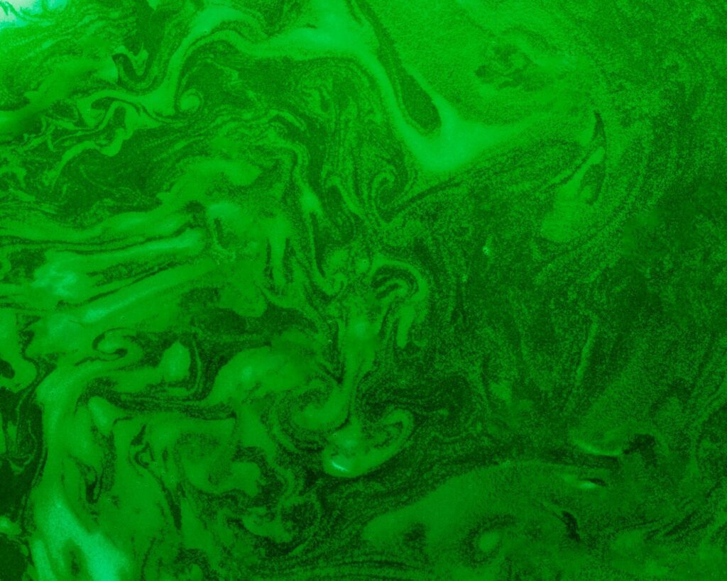 Green abstract swirling pattern with texture.