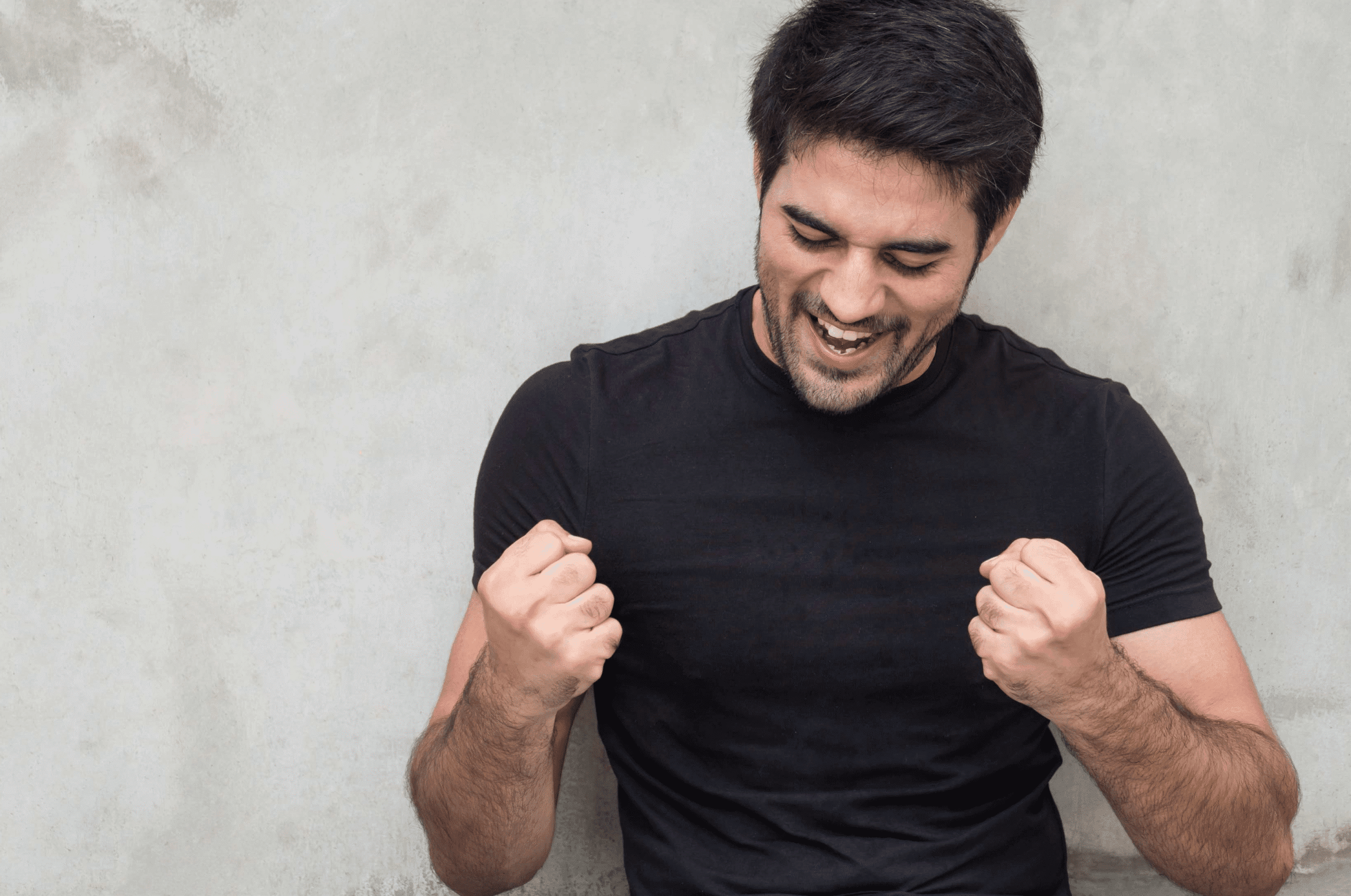 Man celebrating with fists clenched in excitement.