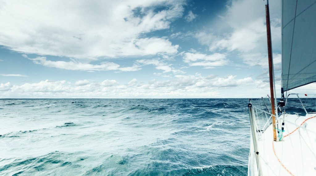 Ocean waves under a cloudy sky.